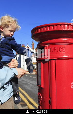 Un enfant en publiant une lettre. Banque D'Images