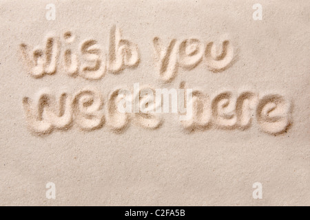Wish You Were Here écrit en sable doré Banque D'Images