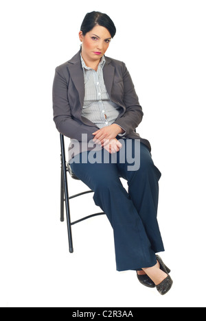 Triste ou fatigué business woman sitting on chair and looking at camera isolé sur fond blanc Banque D'Images