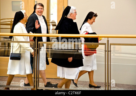 Quatre personnes âgées des religieuses catholiques à pied grâce à un immeuble de bureaux de San Francisco en pleine habitude. Banque D'Images