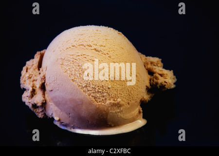 Cram glace scoop sur fond réfléchissant noir Banque D'Images
