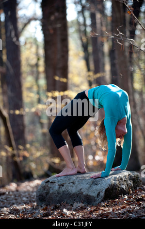 Une femme faisant du yoga postures en plein air. Banque D'Images