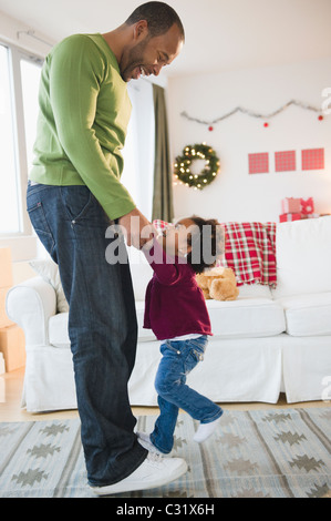 Père et fille noir dancing in living room Banque D'Images