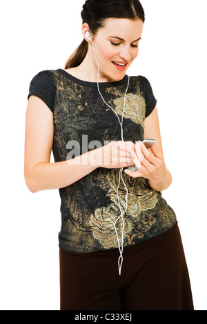 Smiling woman listening to music on MP3 player isolated over white Banque D'Images