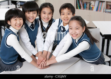 Les élèves blottis ensemble dans la salle de classe Banque D'Images