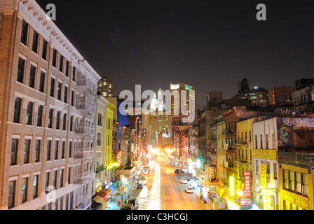 Regardant vers le bas, East Broadway dans Chinatown New York vers le bâtiment municipal de nuit. Banque D'Images