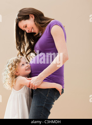 Portrait of Girl (2-3) et de mère enceinte embracing Banque D'Images