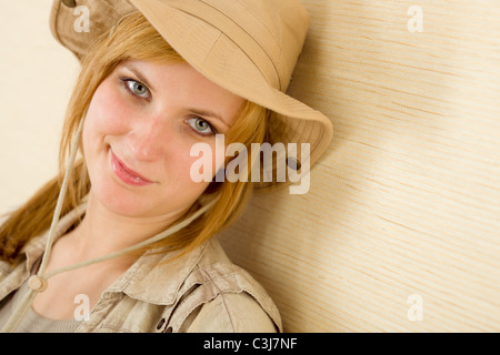 Portrait of happy young woman wear tenue safari hat Banque D'Images