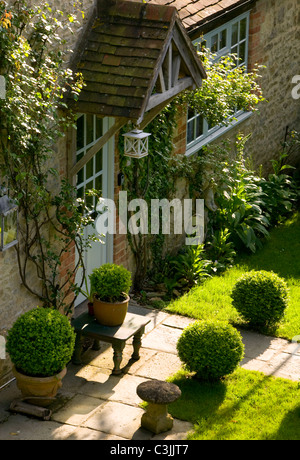 L'ensemble du chemin bordé de pelouse fort topiary menant au porche Chalet jardin d'été en anglais Banque D'Images
