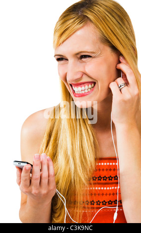 Confident woman listening to music on MP3 player isolated over white Banque D'Images