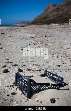Caisse en plastique et des tarballs de déversements d'échouer sur la plage de Balos, sur la péninsule de Gramvousa, dans le nord-ouest de Crète, Grèce. Banque D'Images