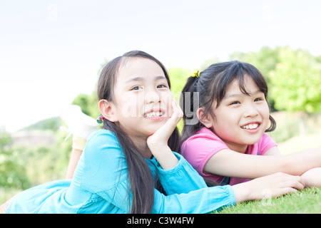Deux Girls Lying on Grass Banque D'Images