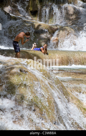 Les touristes s'arrêter de poser pour des photos alors que l'escalade Dunn's Falls à Ocho Rios, Jamaïque. Banque D'Images