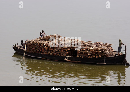 Bateau transportant du bois pour la combustion des Ghats à Ganges, Varanasi, Inde Banque D'Images