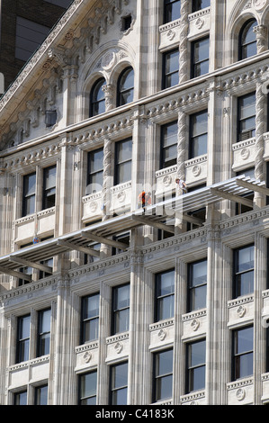 Les travailleurs sur la façade d'un gratte-ciel à Chicago Banque D'Images