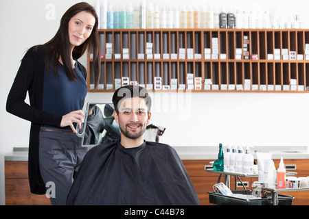 Un client heureux dans un salon de coiffure Banque D'Images