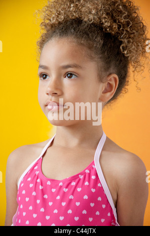 Portrait d'une jeune fille portant un maillot de bain devant des fond jaune Banque D'Images