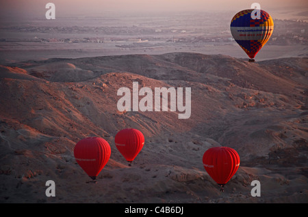 Montgolfières multicolores, monter à l'aube sur la Vallée des Rois et Reines, Al Asasif, Luxor, Egypte Banque D'Images