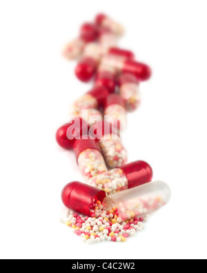 Red pills isolated on white Banque D'Images