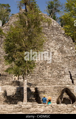 Couple touristique regardant la Iglesia ou pyramide de l'église dans le groupe Cobá aux ruines mayas de Cobá, Quintana Roo, Mexique Banque D'Images