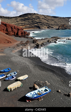 Bateaux de pêche sur la plage volcanique noire de El Golfo, Lanzarote, Canaries Banque D'Images