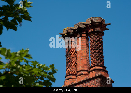 Les cheminées en briques ornée sur une maison d'époque en Angleterre. Banque D'Images