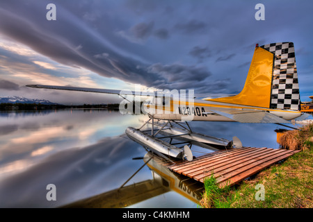 Hydravion amarré sur les eaux calmes du lac des Bois à l'aube à Anchorage, Southcentral Alaska, printemps, HDR Banque D'Images