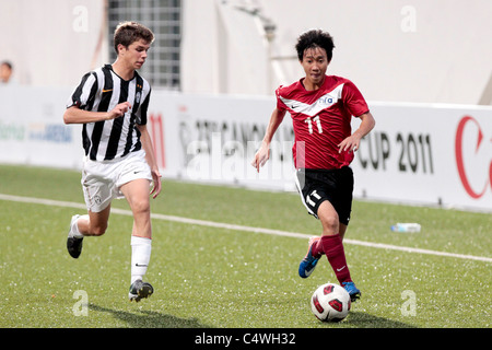 Jonathan Tan de Singapour U16(à droite) reçoit passé Marra Andrea au cours de la 23e Coupe de la ville de Lion de Canon. Banque D'Images