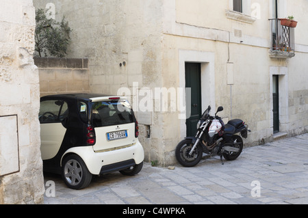 Italie - les sassi de Matera. Les petites voitures et scooters sont meilleures dans les étroites rues et ruelles escarpées du Sasso Barisano. Banque D'Images