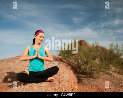 USA,Arizona,Phoenix,young woman practicing yoga on desert Banque D'Images