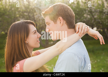 USA, Utah, Provo, Young couple embracing in orchard