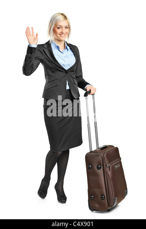 Blonde femme portant ses bagages et gesturing Banque D'Images