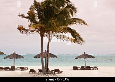 Chaises de plage et parasols au Canouan Estate Resort & Villas à Carenage Bay, île de Canouan, Saint-Vincent-et-les Grenadines. Banque D'Images