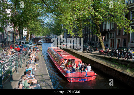 Une barge à voiles vers le bas d'un canal pittoresque dans la ville néerlandaise d'Amsterdam. Banque D'Images