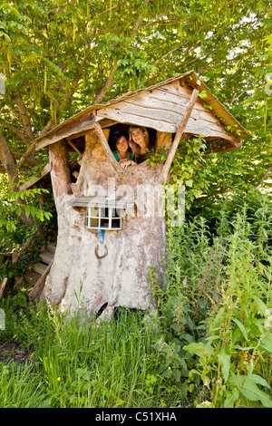 Deux jeunes femmes dans de beaux arbres traditionnels ou Wendy maison construite par Clifford Matthews pour ses petits-enfants. JMH5135 Banque D'Images