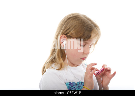 Une jeune fille portant des bourgeons de l'oreille de l'écoute d'un MP3 (ipod nano) tourné sur un fond blanc. Banque D'Images