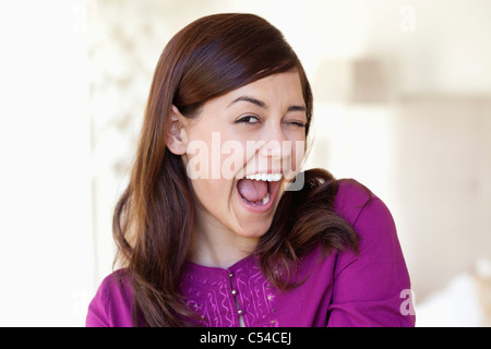 Portrait of a young woman winking Banque D'Images