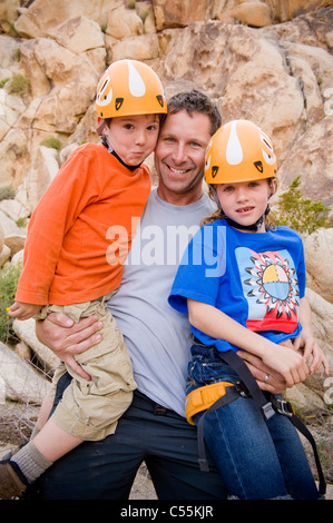 Mid adult man carrying ses filles, Joshua Tree National Monument, California, USA Banque D'Images