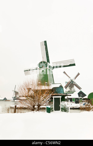 Zaanse Schans, village sur les rives de la rivière Zaan avec maisons en bois verte caractéristique, historique des moulins à vent. L'hiver, la neige. Banque D'Images