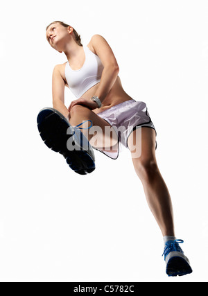 Low angle view of woman stretching Banque D'Images