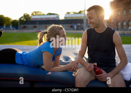 Athletic couple relaxing in stadium Banque D'Images