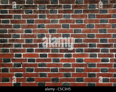 Mur de brique rouge et noir avec du mortier blanc Banque D'Images