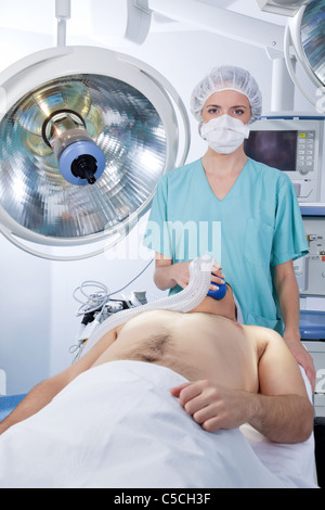 Femme médecin l'application de masque à gaz à un patient dans l'hôpital Banque D'Images