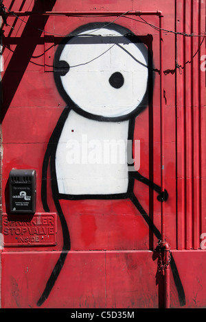 Stik figure peint sur un front Shop, Commercial Road London, UK. Banque D'Images