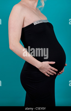 Pregnant woman holding her belly Banque D'Images