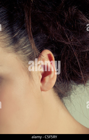 Closeup of a young woman's ear Banque D'Images