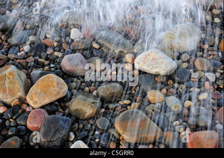 L'eau colorée cailloux lissés en surf à galets, Normandie, France Banque D'Images