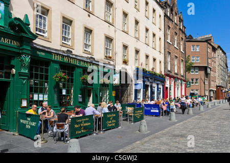 Les gens assis à l'extérieur d'un pub (The White Hart Inn) sur Grassmarket dans la vieille ville, Édimbourg, Écosse, Royaume-Uni Banque D'Images