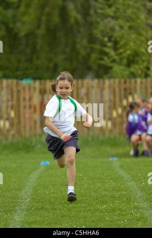 Jeune fille en compétition dans l'exécution de course sur sportsday Banque D'Images