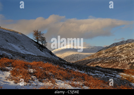 Beinn couverte de neige en verre bleu gris lumière sous un ciel d'hiver avec le sommet ensoleillé de Ben Lawers juste montrer, près de Banque D'Images